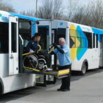 Personne en fauteuil roulant descendant d'un mini-bus de la STM